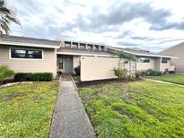 Inviting single-story home featuring a manicured lawn and charming front walkway at 5225 Imperial Lakes Blvd # 49, Mulberry, FL 33860