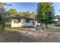 Charming single-story home with white siding, black trim, and well-maintained landscaping at 5420 Ivory Ln, Lakeland, FL 33811
