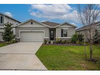 Charming single-story home with a two-car garage, manicured lawn and stone accents at 5431 Arlington River Dr, Lakeland, FL 33811