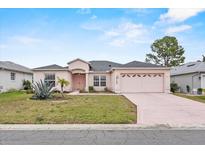 Charming single Gathering home features a well-manicured lawn and attached two-car garage at 5725 Mallard Dr, Lakeland, FL 33809