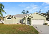 Charming single-story home featuring a well-manicured lawn and attached two-car garage at 7211 Scenic Hills Blvd, Lakeland, FL 33810