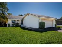 Charming single-story home with well-manicured lawn and attached two-car garage at 4315 Larrys Lagoon, Winter Haven, FL 33884