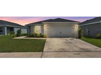 Charming single-story home featuring a well-manicured lawn and an attached two-car garage at 4424 Reding Way, Lakeland, FL 33813