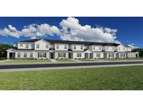 New townhomes feature a stylish exterior design with a manicured lawn and welcoming entrances at 5750 Anders Way, St Cloud, FL 34771