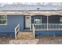 Charming blue home with a welcoming front porch and a classic white door at 6029 Tancrede Ct, Lakeland, FL 33811