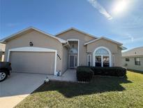 Charming single-story home with a manicured lawn, attached garage and welcoming front entrance with updated landscaping at 6059 Swallow Dr, Lakeland, FL 33809