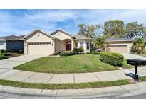 Charming single-story home with manicured lawn, two-car garage, and welcoming front entrance at 6907 Eagle Ridge Blvd, Lakeland, FL 33813