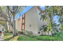 Well-maintained exterior of a multi-story residential building, surrounded by mature trees and landscaping at 1130 N Lake Parker Ave # C328, Lakeland, FL 33805