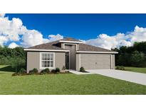 Charming single-story home featuring neutral stucco, a two-car garage, and a well-manicured lawn at 1327 Mottled Duck Ln, Lakeland, FL 33811