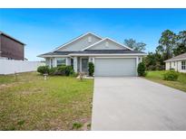 Charming single-story home featuring a well-maintained lawn and attached two-car garage at 2085 Pecos Dr, Kissimmee, FL 34759