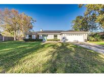 Charming single-story home with a well-manicured front lawn and a welcoming light blue front door at 4120 Old Colony Rd, Mulberry, FL 33860