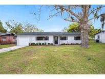 Charming single-story home featuring a well-maintained lawn, fresh exterior paint, and a classic front door at 1180 E Hill Ct, Bartow, FL 33830