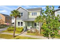 Charming two-story home with a well-maintained lawn and lush landscaping, including palm trees at 13119 Granger Ave, Orlando, FL 32827