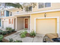 Charming yellow two-story home with attached garage and well-maintained landscaping at 726 Chacall Loop, Mount Dora, FL 32757