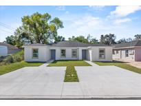 Charming duplex featuring a well-maintained lawn and spacious concrete driveway at 302 Ave P Nw, Winter Haven, FL 33881