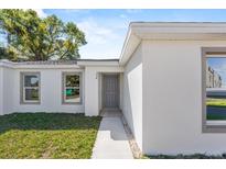 Charming single-story home with a well-maintained lawn and neutral-colored exterior at 304 Ave P Nw, Winter Haven, FL 33881