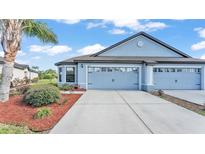 Charming single-Gathering home with a two-car garage, manicured landscaping, and a beautiful lawn at 5883 Great Salt Ct, Lakeland, FL 33805
