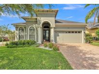 Charming single-story home featuring a well-manicured lawn and a welcoming arched entryway at 914 Christina Chase Dr # Drive, Lakeland, FL 33813