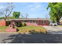 Charming brick home with well-maintained lawn and landscaping, showcasing curb appeal at 1306 N Webster Ave, Lakeland, FL 33805