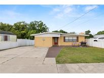 Charming single-story home with a large driveway and fenced front yard at 2111 S Lincoln Ave, Lakeland, FL 33803
