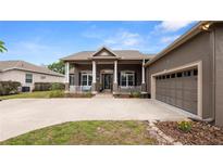 Charming home featuring a spacious front porch with classic columns and a two-car attached garage at 2569 Colonel Ford Dr, Lakeland, FL 33813