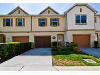 Inviting townhome featuring a well-maintained lawn and private garage, perfect for convenient living at 3846 Exeter Ln, Lakeland, FL 33810