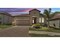 Charming single-Gathering home with a two-car garage, manicured lawn, and colorful landscaping at 4232 Prima Lago Dr, Lakeland, FL 33810
