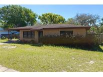 Charming single story brick home with a well-maintained lawn and mature landscaping at 460 W Pierce St, Lake Alfred, FL 33850