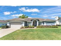 Charming single-story home with a well-manicured lawn and beautiful landscaping at 5638 Bloomfield Blvd, Lakeland, FL 33810