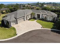 Stunning single-story home featuring a circular driveway and a three-car garage at 6470 Ashley Dr, Lakeland, FL 33813