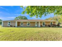 Charming single-story home with a well-manicured lawn, front porch, and a welcoming front door at 6981 Snell Rd, Bartow, FL 33830
