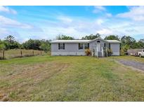 Charming single-story home featuring a front porch and spacious yard at 900 Saddlewood Blvd, Lakeland, FL 33809