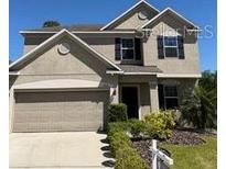 Charming two-story home with attached two car garage and manicured landscaping at 1018 Roberta Rd, Lake Wales, FL 33853