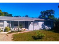 Charming single-story home featuring a well-maintained lawn and inviting covered front porch at 1024 31St Nw St, Winter Haven, FL 33881