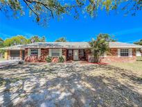 Charming brick home with well-maintained landscaping, front lawn and double-door garage at 3335 Wren Ln, Mulberry, FL 33860