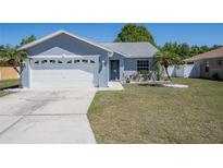 Charming single-story home featuring a well-manicured lawn, attached two-car garage, and cheerful curb appeal at 3427 Imperial Manor Way, Mulberry, FL 33860