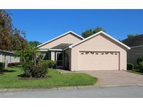 Charming single-story home features a manicured lawn, brick driveway and a two car garage at 3817 Osprey Pointe Cir, Winter Haven, FL 33884