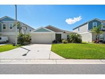 Well-maintained single story home with lush lawn, mature palms and a two car garage at 5543 Arlington River Dr, Lakeland, FL 33811