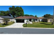 Well-maintained single-story home featuring a lush green lawn, driveway, and an attached garage at 8181 Bristol Bay Ave, Lakeland, FL 33810