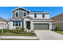 Charming two-story home featuring a well-manicured lawn and a two-car garage at 823 Folklore Ln, Haines City, FL 33844