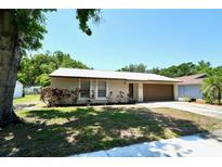 Charming single-story home with well-maintained landscaping and a metal roof at 1618 Crystalview Trl, Lakeland, FL 33801
