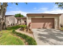 An exterior image of a well-maintained single story home with beautiful landscaping and healthy green foliage at 3545 Harbor Nw Cir, Winter Haven, FL 33881