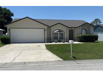 Charming single-story home featuring a two-car garage and well-maintained landscaping at 7968 Charleston Blvd, Lakeland, FL 33810