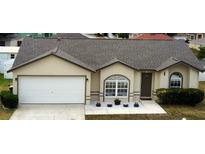 Charming single-story home with a two-car garage, manicured lawn, and neutral color palette at 7968 Charleston Blvd, Lakeland, FL 33810