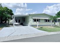 Inviting single-story home with carport, landscaped yard, and charming curb appeal at 1011 Pine Ridge Dr, Lakeland, FL 33809