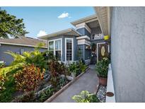 Inviting front entrance featuring a landscaped walkway and charming curb appeal at 1573 Avleigh Cir, Orlando, FL 32824
