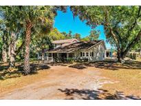 Charming two-story home with a light gray exterior, mature trees, and a large front yard at 2319 D R Bryant Rd, Lakeland, FL 33810