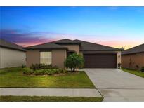 Charming single-story home with a well-manicured lawn, complemented by a two car garage and beautiful landscaping at 2726 Red Egret Dr, Bartow, FL 33830