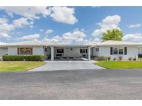 Charming home with a pristine white exterior, covered carport, and well-manicured lawn at 3570 Milano Ave # 3570, Lakeland, FL 33803