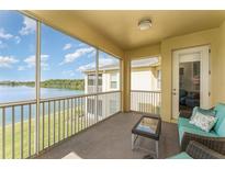Relaxing screened-in patio with comfortable seating and a beautiful lake view at 3923 Serenade Ln # 426, Lakeland, FL 33811